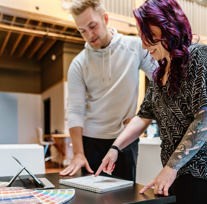 Two people collaborating over a design project.