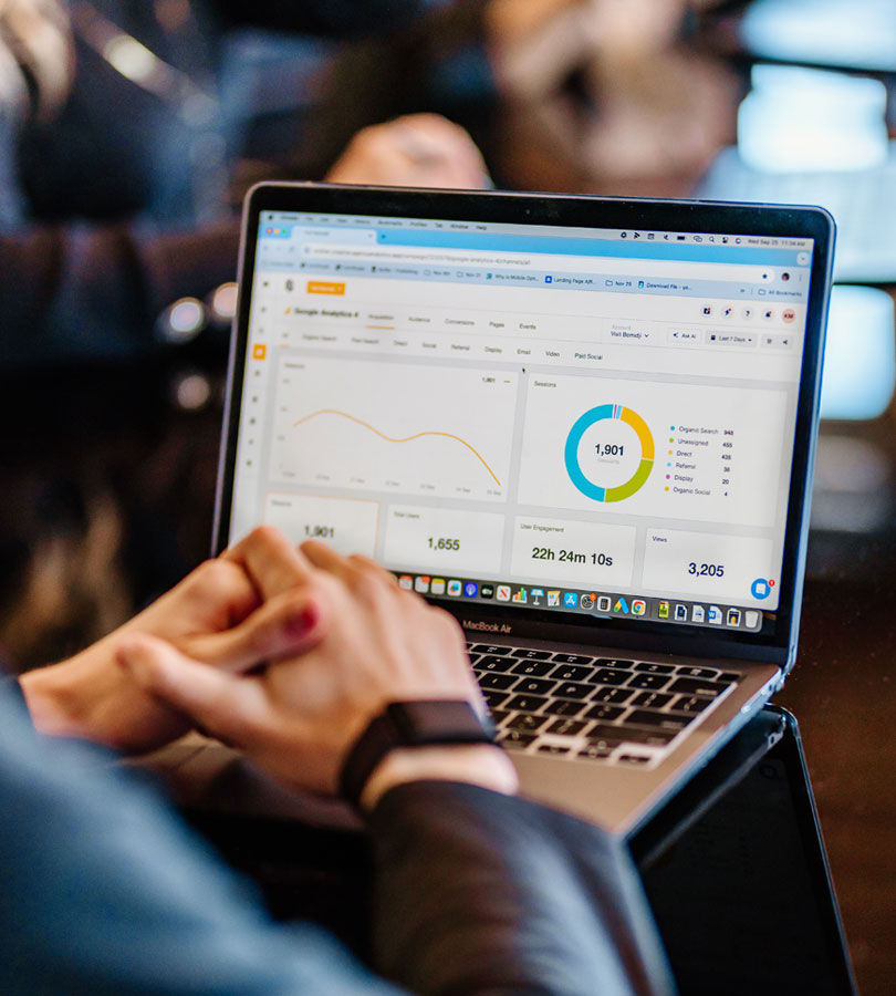 Person analyzing marketing data on laptop.