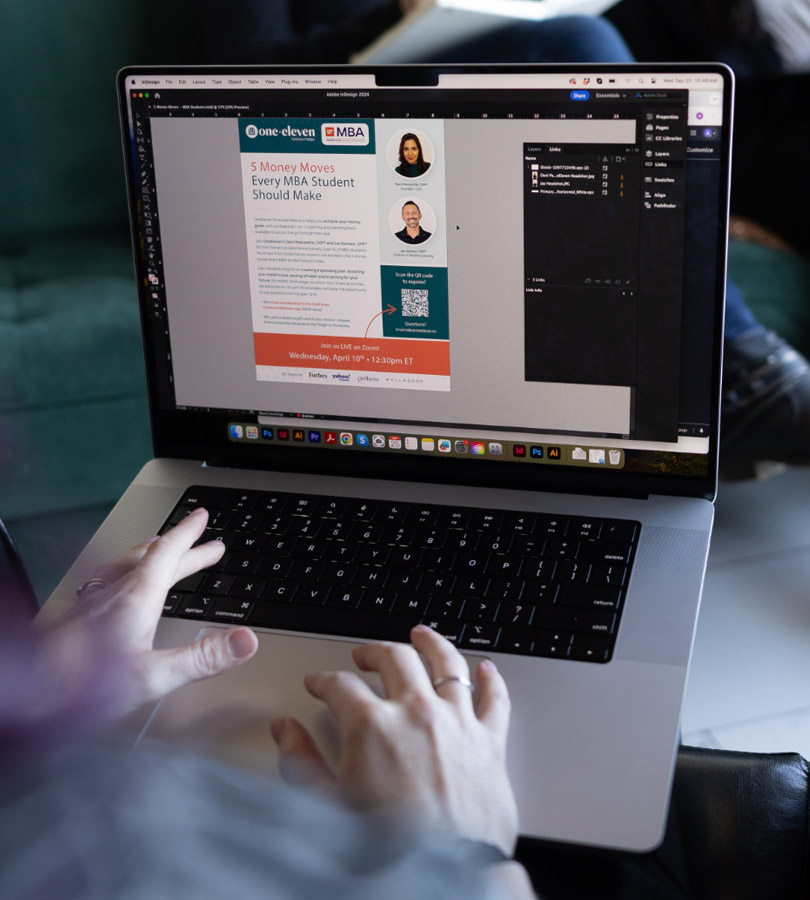 Person designing educational flyer on laptop.