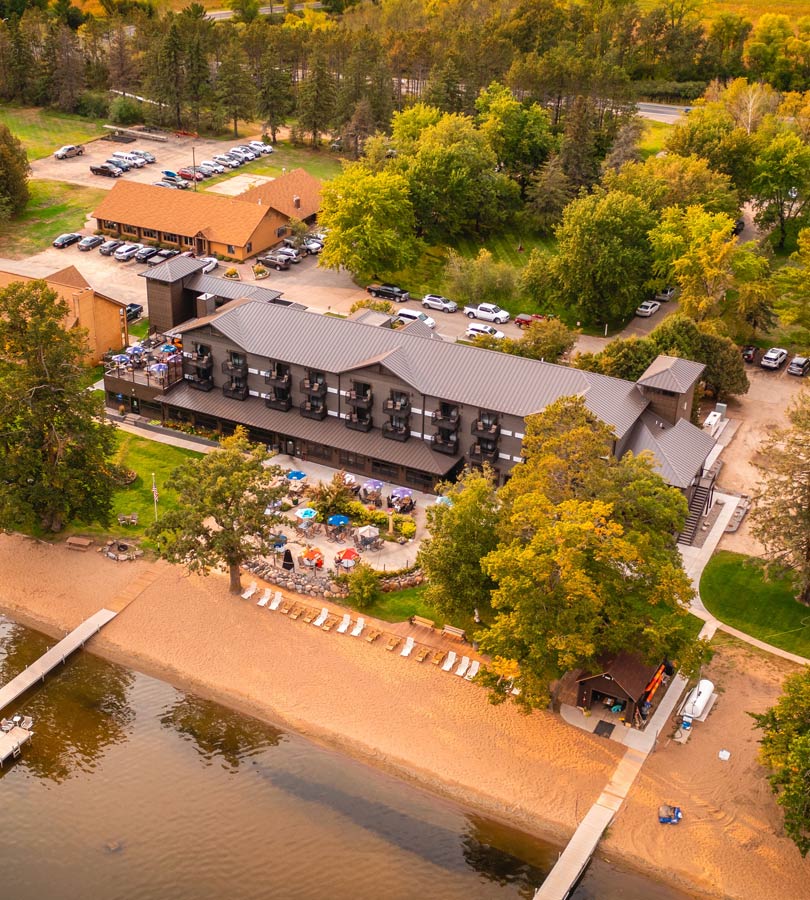 Aerial view of lakeside resort with beach.