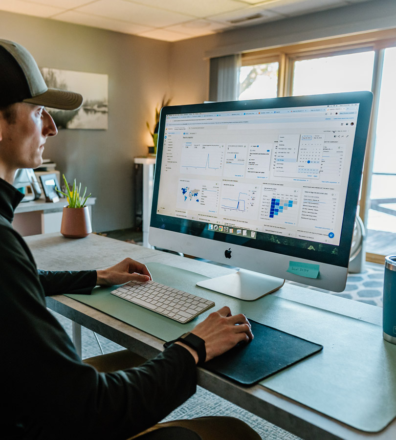 Man analyzing data on desktop computer at home