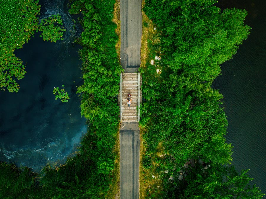 Aerial view of people on bridge over river.