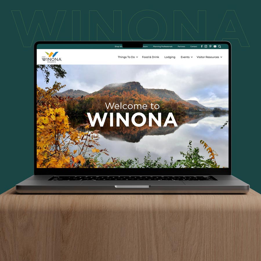 Laptop displaying 'Welcome to Winona' home page